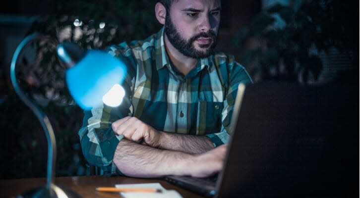 Worried man looking at his financial records on a home computer