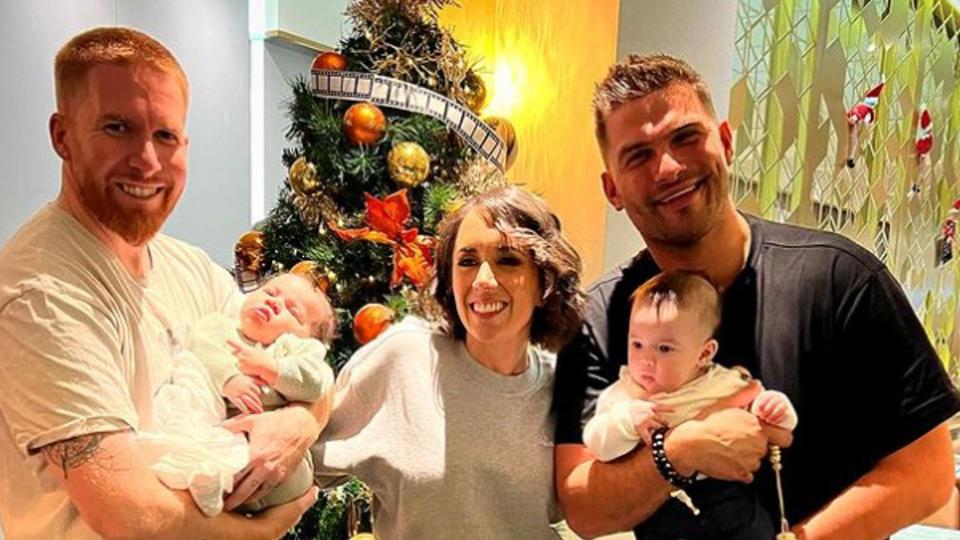 Neil Jones and his baby daughter standing with Janette Manrara, Aljaz Skorjanec and their baby daughter