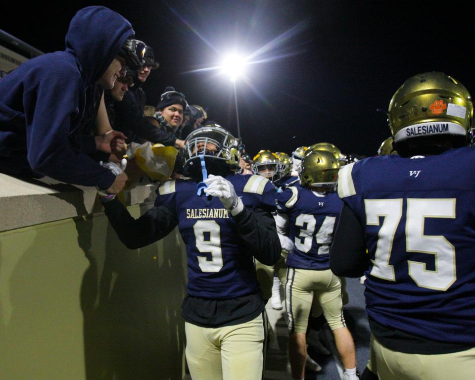 Salesianum's L.J. Smith (9) celebrates with the student section after Salesianum's 24-14 win against Middletown in a DIAA Class 3A state tournament semifinal at Abessinio Stadium, Friday, Nov. 24, 2023.