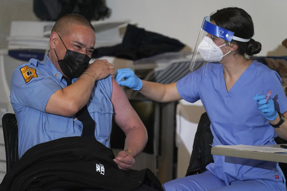 New York City firefighter emergency medical services personnel are vaccinated against COVID-19 at the FDNY Fire Academy in New York, Wednesday, Dec. 23, 2020. (AP Photo/Seth Wenig)