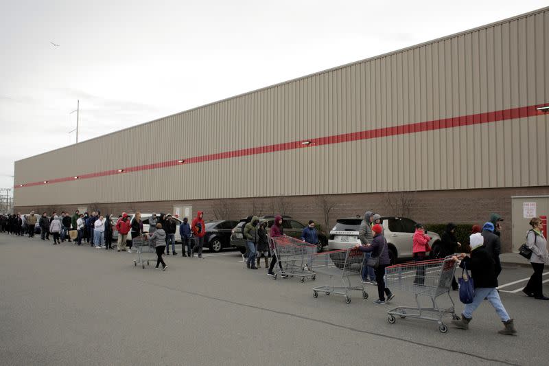 Shoppers line up before opening at a Costco store, following reports of coronavirus disease (COVID-19) cases in the country, in Seattle
