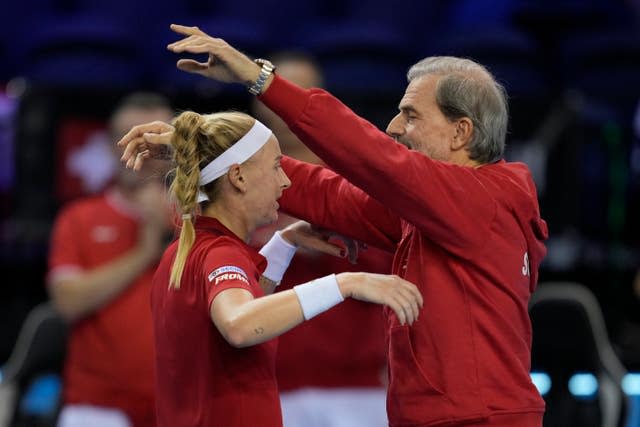 Jil Teichmann of Switzerland and captain Heinz Gunthardt celebrate her three-hour victory