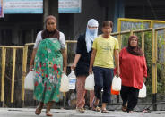 <p>Residents who were displaced due to fighting between government soldiers and the Maute militant group, carry plastic containers of water in Marawi City in southern Philippines May 28, 2017. (Erik De Castro/Reuters) </p>