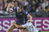 New Zealand's captain Risi Pouri-Lane tackles Lauren Doyle, captain of team United States, during the women's final match in the Hong Kong Sevens rugby tournament in Hong Kong, Sunday, April 7, 2024. (AP Photo/Louise Delmotte)