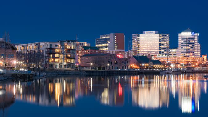 WILMINGTON, DE - APRIL 5, 2018: Wilmington, Delaware night skyline and Riverwalk  along the Christiana River.