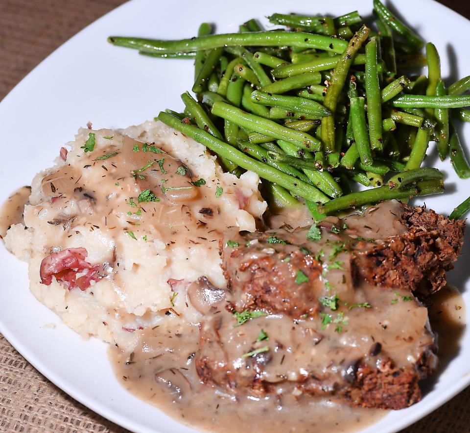 This is a file photo of Downtown Deli & Donuts' vegan lentil loaf with portobello gravy and mashed potatoes with roasted haricot vert.