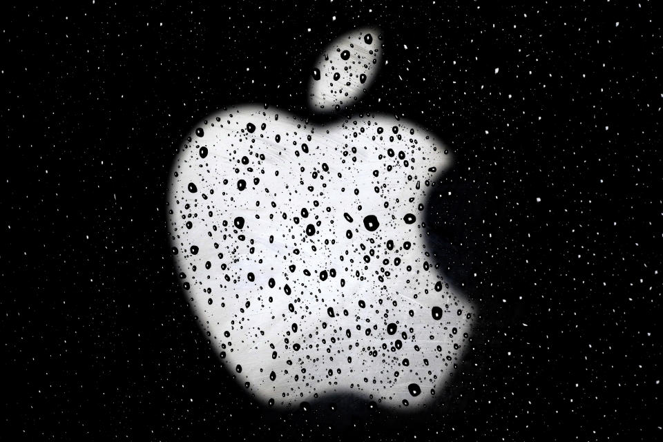 An Apple logo is seen in tiny lenses formed by raindrops on a window outside an Apple Store at the Country Club Plaza shopping district Wednesday, Dec. 26, 2018, in Kansas City, Mo. (AP Photo/Charlie Riedel)