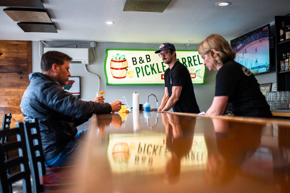 Bartender Alcario Artuso, center, works the bar at Pickle Barrel in Fort Collins on Mar. 1, 2023.