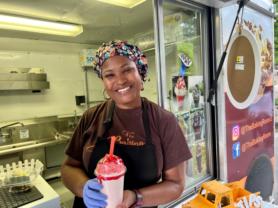 T.C. Woodard, owner of The Baking Room, poses with this strawberry cheesecake milkshake, created June 22, 2023, in the downtown Nashville Street Eats pop-up food truck park.