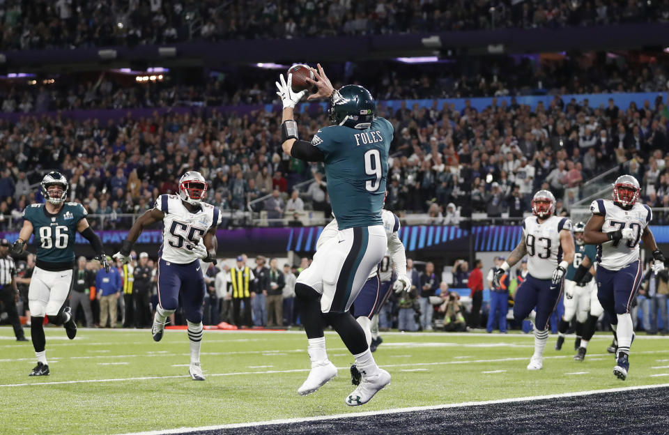 FILE - In this Feb. 4, 2018, file photo, Philadelphia Eagles' Nick Foles catches a touchdown pass during the first half of the NFL Super Bowl 52 football game against the New England Patriots, in Minneapolis. Rookie running back Corey Clement took the snap out of shotgun formation, rolled to his left and pitched the ball to third-string tight end Trey Burton, who caught it coming off the end, ran a few steps and floated a pass to backup quarterback Nick Foles in the end zone for a touchdown. Facing the mighty New England Patriots on the NFL's biggest stage, Philadelphia Eagles coach Doug Pederson's decision to try a trick play on a fourth down late in the first half of Super Bowl 52 will be remembered as one of the gutsiest calls in sports history. (AP Photo/Jeff Roberson, File)