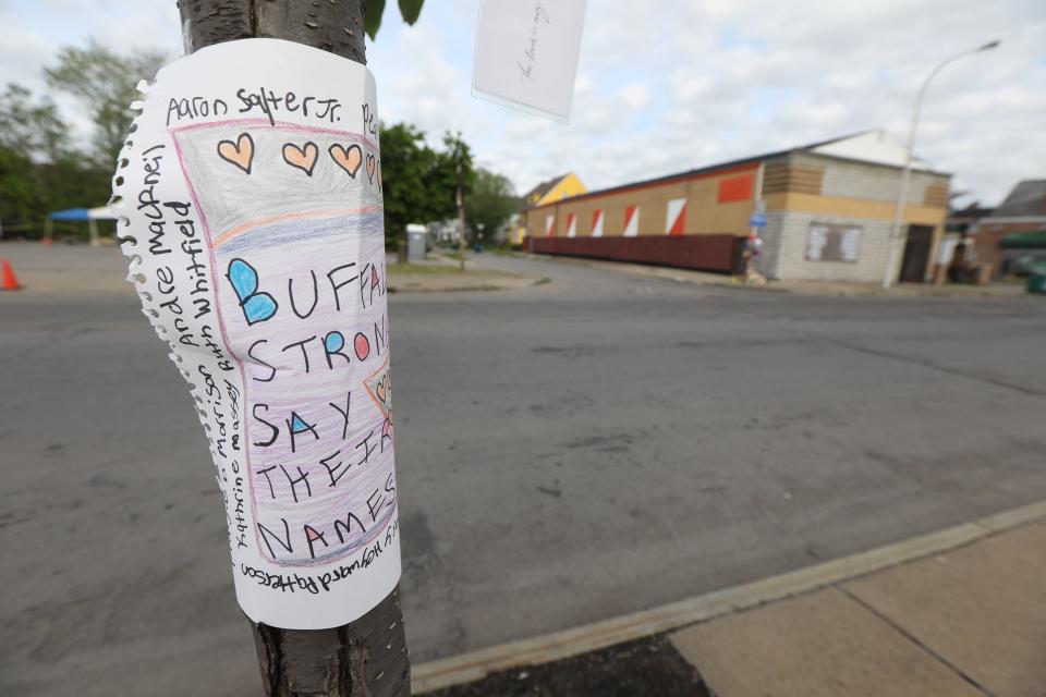 The plaza and surrounding streets are filled with memorials on May 25, 2022 for the people who were killed in a racially motivated shooting at Tops Friendly Market on Jefferson Ave. in Buffalo, NY on May 14.  This sign was wrapped around a pole on Jefferson Ave.