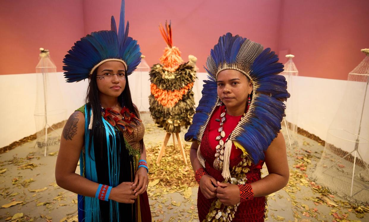 <span>Glicéria Tupinambá (right, with her niece Jessica) in the Brazilian pavilion at Venice, which features the Tupinambá cloak, along with letters asking for its return.</span><span>Photograph: David Levene/The Guardian</span>