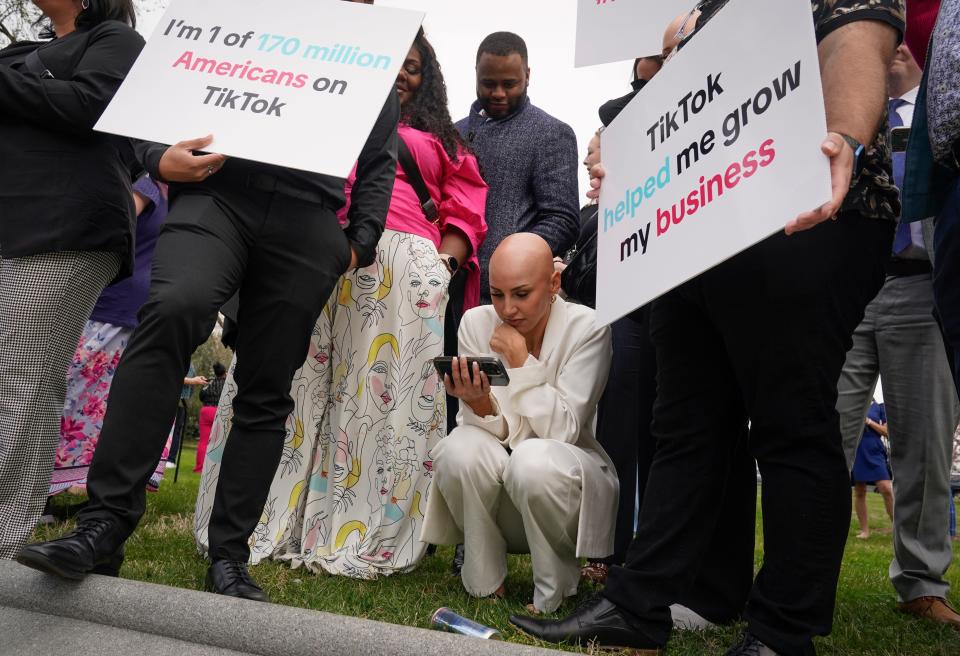 Protesters watch from outside the U.S. Capitol as the House approved a bill Wednesday that would force TikTok’s parent company to sell the popular social media app or face a practical ban in the U.S.
