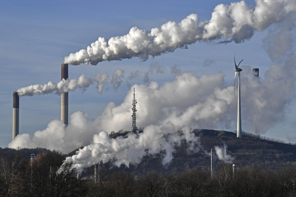 FILE --- This Jan. 16, 2020 file photo shows a Uniper energy company coal-fired power plant and a BP refinery beside a wind generator in Gelsenkirchen, Germany. The German government is to agree its national hydrogen strategy for the coming decades, part of a plan to reduce the country's dependence on fossil fuels. (AP Photo/Martin Meissner, file)
