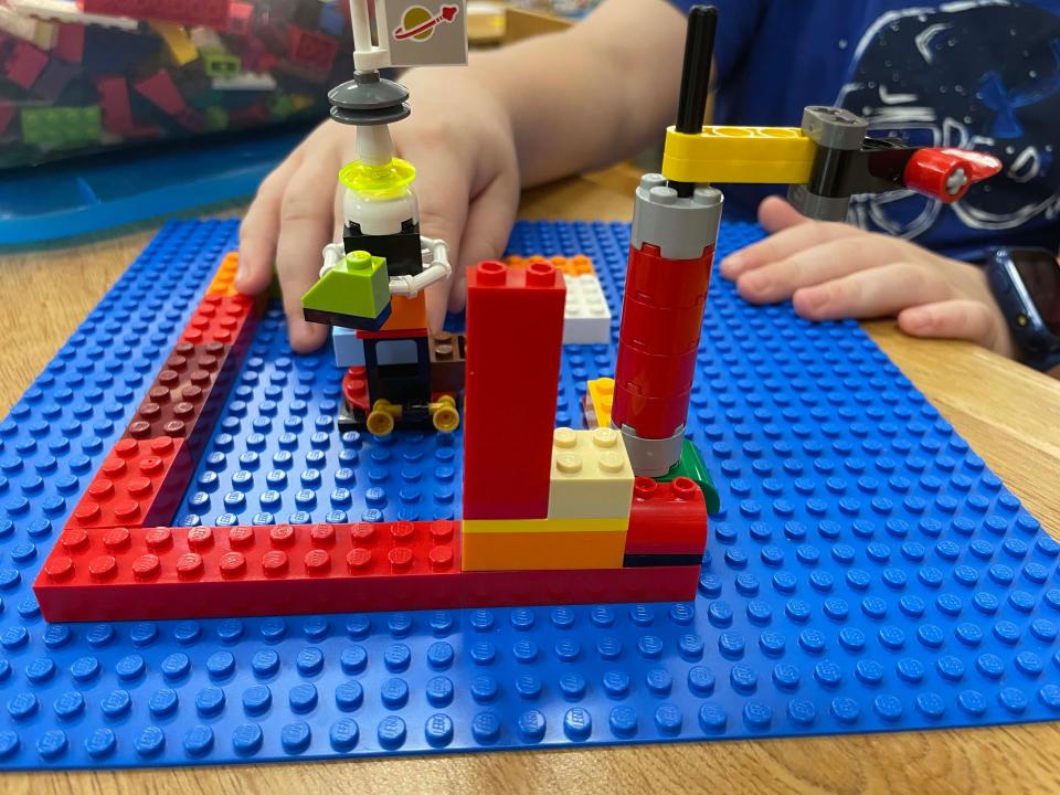 Just barely underway, Easton Baumgardner, 9, builds a naval base with defensive turrets at the monthly LEGO Club held at Karns Branch Library Saturday, May 21, 2022. He says it will have many airplanes by the time he’s finished.