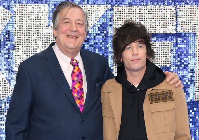 <p>Karwai Tang/WireImage</p> Stephen Fry and Elliott Spencer in 2019