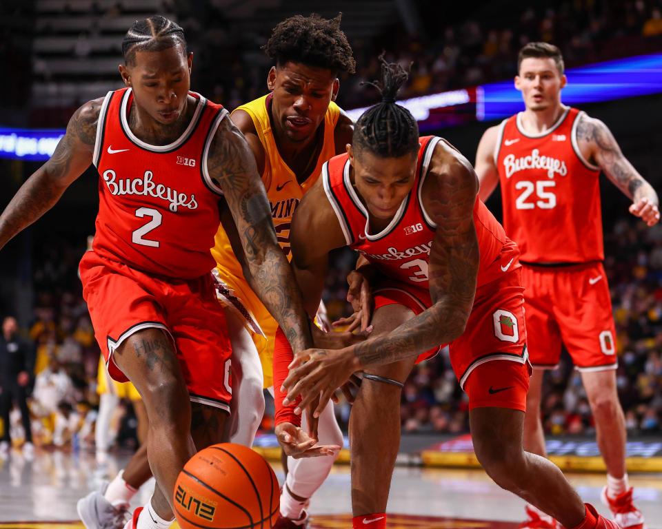 Ohio State's Cedric Russell (2) and Eugene Brown III battle Minnesota's Abdoulaye Thiam for the ball Sunday.