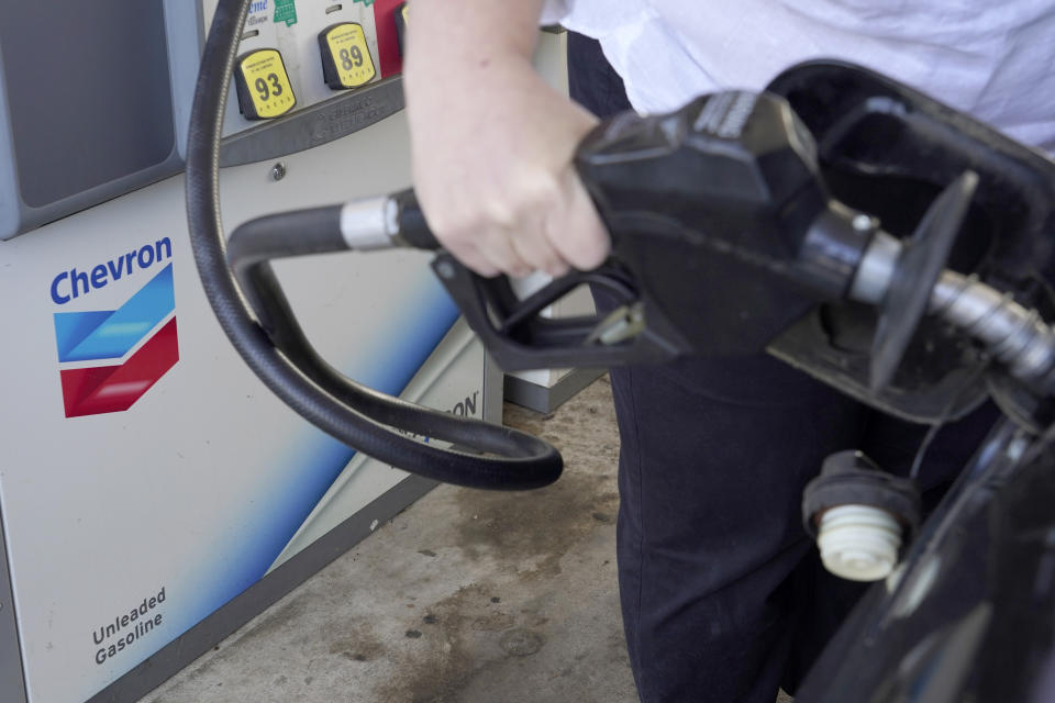 A customer pumps gas at a Chevron station in Columbus, Miss., Monday, Oct. 23, 2023. Chevron is buying Hess Corp. for $53 billion as major producers seize the initiative while oil prices surge. (AP Photo/Rogelio V. Solis)