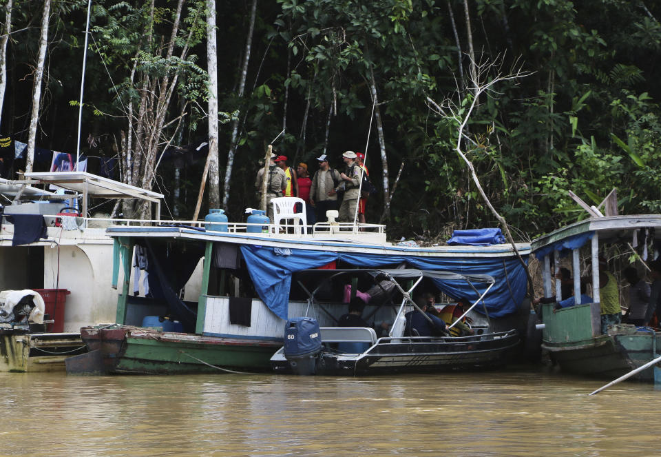 Firefighters gather at a camp set up by Indigenous people to search for Indigenous expert Bruno Pereira and freelance British journalist Dom Phillips in Atalaia do Norte, Amazonas state, Brazil, Tuesday, June 14, 2022. The search for Pereira and Phillips, who disappeared in a remote area of Brazil's Amazon continued following the discovery of a backpack, laptop and other personal belongings submerged in a river. (AP Photo/Edmar Barros)