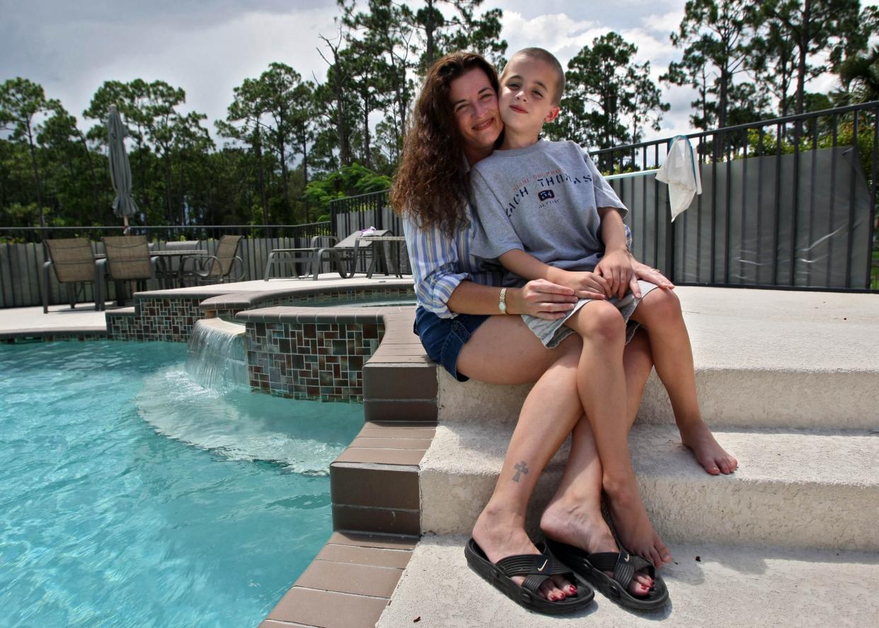 In this June 2009 photo, Jennifer Dunsford sits with her 6-year-old son, Garrett, who had a brain tumor operated on over a year ago. Dunsford at the time was gathering information on who has cancer in the area for the Florida Department of Health after finding out three other children in the area have had brain tumors removed. Another neighbor died from a brain tumor.