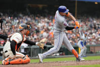 New York Mets' Tyrone Taylor, right, hits a two-run double in front of San Francisco Giants catcher Patrick Bailey during the fifth inning of a baseball game in San Francisco, Wednesday, April 24, 2024. (AP Photo/Jeff Chiu)