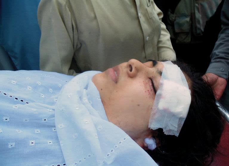 Pakistani hospital workers carry injured Malala Yousafzai, 14, on a stretcher at a hospital following an attack by gunmen in Mingora on October 9, 2012