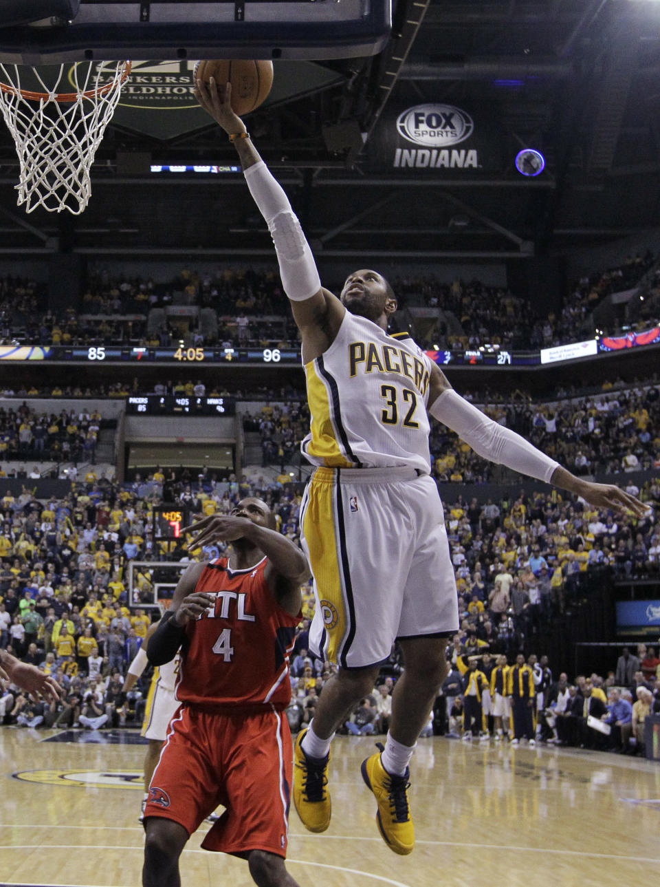 Indiana Pacers' C.J. Watson (32) puts up a shot against Atlanta Hawks' Paul Millsap (4) during the second half in Game 5 of an opening-round NBA basketball playoff series Monday, April 28, 2014, in Indianapolis. Atlanta defeated Indiana 107-97. (AP Photo/Darron Cummings)