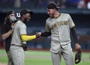 San Diego Padres' Jurickson Profar, left, shakes hands with pitcher Joe Musgrove (44) after Musgrove's no-hitter against the Texas Rangers during a baseball game Friday, April 9, 2021, in Arlington, Texas. (AP Photo/Richard W. Rodriguez)