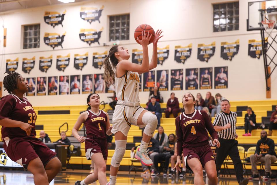 Garfield senior point guard Laura McCoy goes up for a shot during Thursday night's basketball game against the Liberty Leopards at James A. Garfield High School.