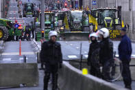 Farmers with their tractors begin to arrive, near the European Quarter in Brussels, during a demonstration outside of a meeting of EU agriculture ministers at the European Council building in Brussels, Tuesday, March 26, 2024. Tuesday marks the third time this year that farmers will take to the streets of Brussels with their tractors. (AP Photo/Virginia Mayo)