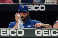 A night after being hit in the face with a fast ball New York Mets' Kevin Pillar holds an ice pack to his face as he watches from the during a baseball game Tuesday, May 18, 2021, in Atlanta. (AP Photo/John Bazemore)