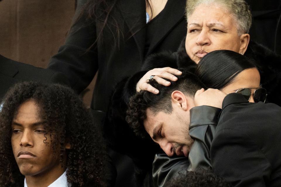 Mourners gather as a honor guard carries the casket containing the remains of Temple University Police Officer Christopher Fitzgerald.