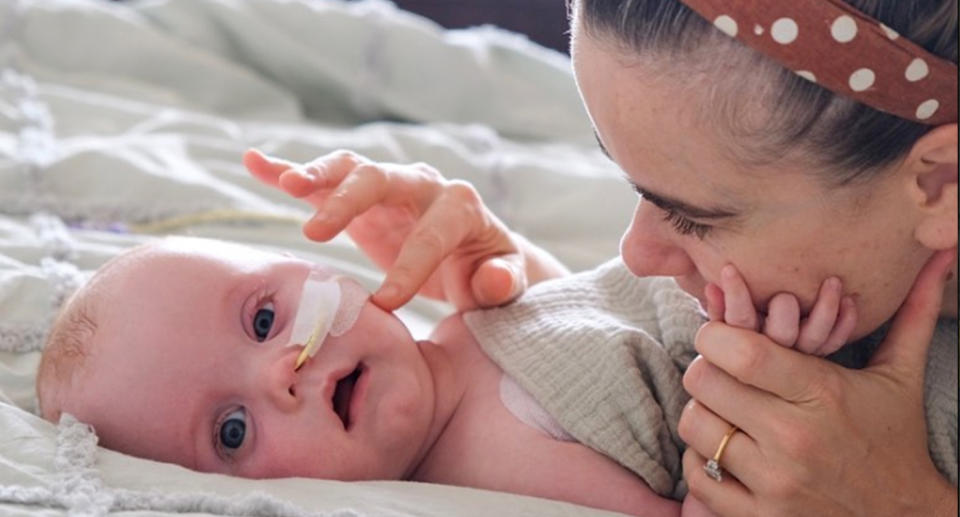 Brooke Carter caressing Hugo, who has a tube in his nose.