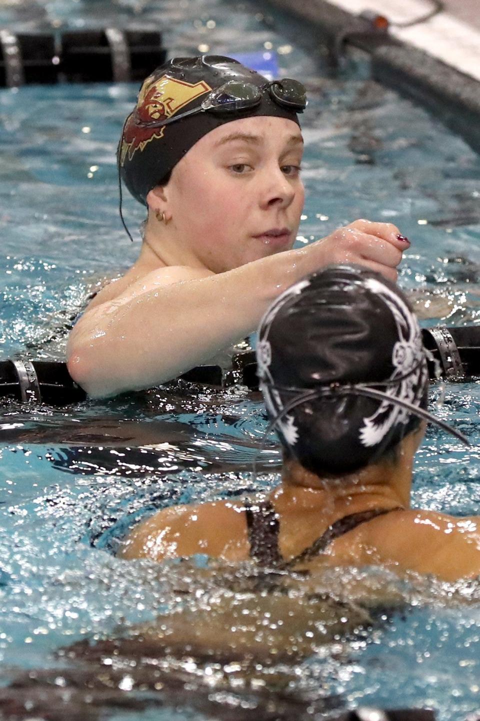 New Albany's Carly Meeting congratulates Westerville Central's Kiah Smith after the 50-yard freestyle during the OHSAA Division I State Swimming Tournament on Feb. 25, at the C.T. Branin Natatorium in Canton.