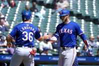 Texas Rangers catcher Jonah Heim celebrates his two-run home run with Wyatt Langford (36) against the Detroit Tigers in the second inning of a baseball game, Thursday, April 18, 2024, in Detroit. (AP Photo/Paul Sancya)