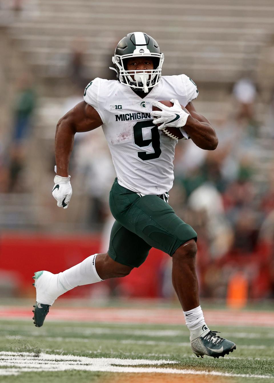 Few fans watched from the stands behind Michigan State running back Kenneth Walker III as he ran against host Rutgers during the second half of their Big Ten Conference matchup on Oct. 9. Nationally-ranked Michigan State won 31-13.