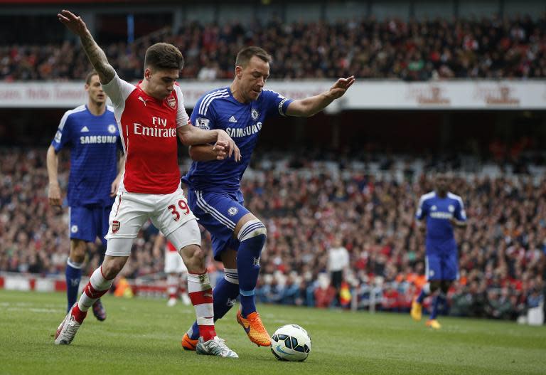 Arsenal's Hector Bellerin (left) vies with Chelsea's John Terry during their Premier League match at the Emirates Stadium in London on April 26, 2015