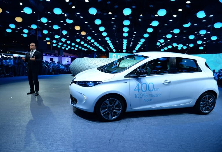 CEO French carmaker Renault, Carlos Ghosn, talks in front of an electric car on the first press day of the Paris motor Show, on September 29, 2016