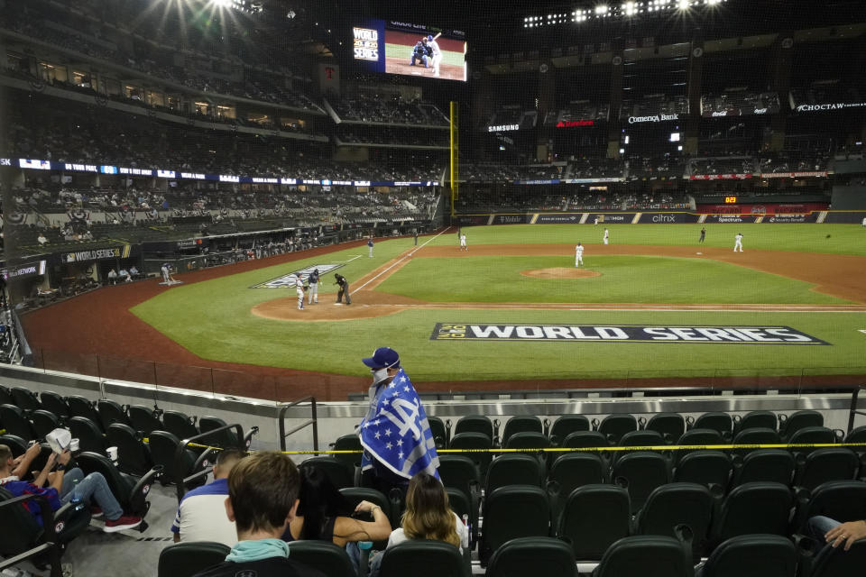 Fans watch during the sixth inning in Game 1 of the baseball World Series between the Los Angeles Dodgers and the Tampa Bay Rays Tuesday, Oct. 20, 2020, in Arlington, Texas. (AP Photo/Eric Gay)