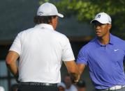 Phil Mickelson (L) greets playing partner Tiger Woods, both of the U.S. on the 10th tee before teeing off during the first round of the 2014 PGA Championship at Valhalla Golf Club in Louisville, Kentucky, August 7, 2014. REUTERS/Brian Snyder