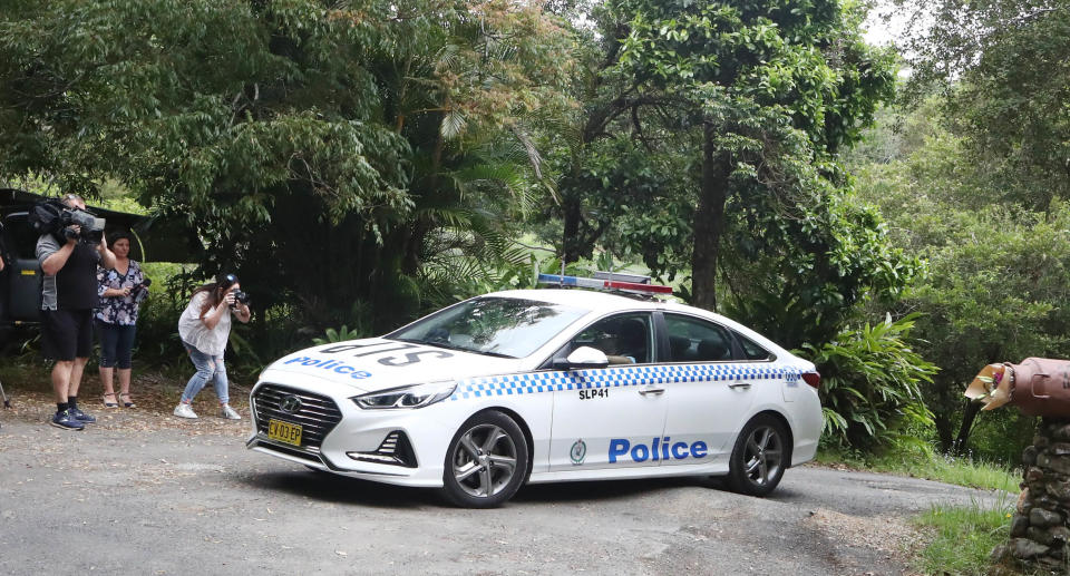 A police car leaves the driveway of a home where twin four-year-old girls died following a house fire, in Goonengerry, west of Byron Bay, Sunday , November 7, 2021. Source: AAP