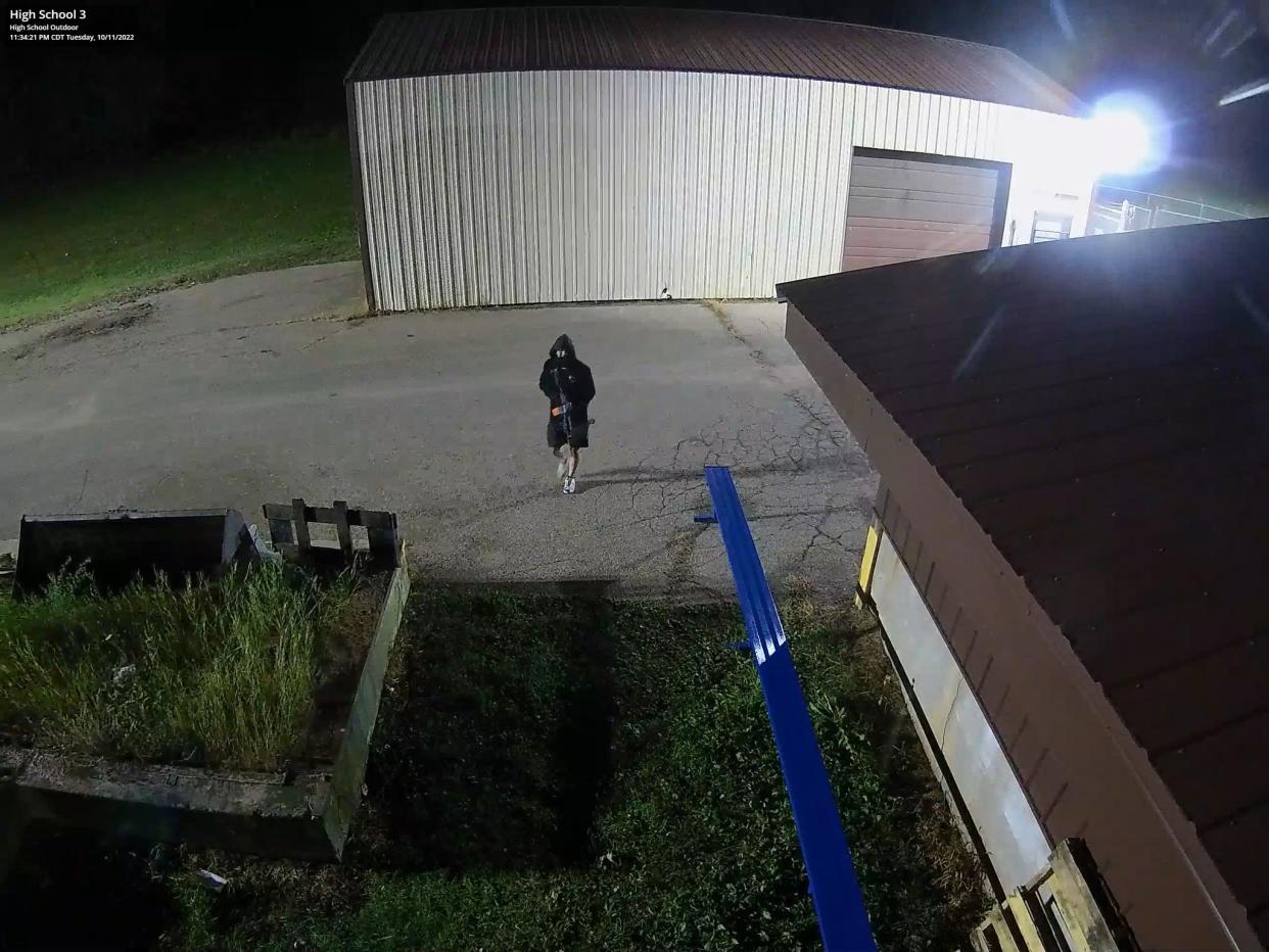 A still of surveillance footage of an individual suspected to have damaged Menominee Indian High School buildings, taken at 11:34 p.m. October 11 in Keshena, Wis.