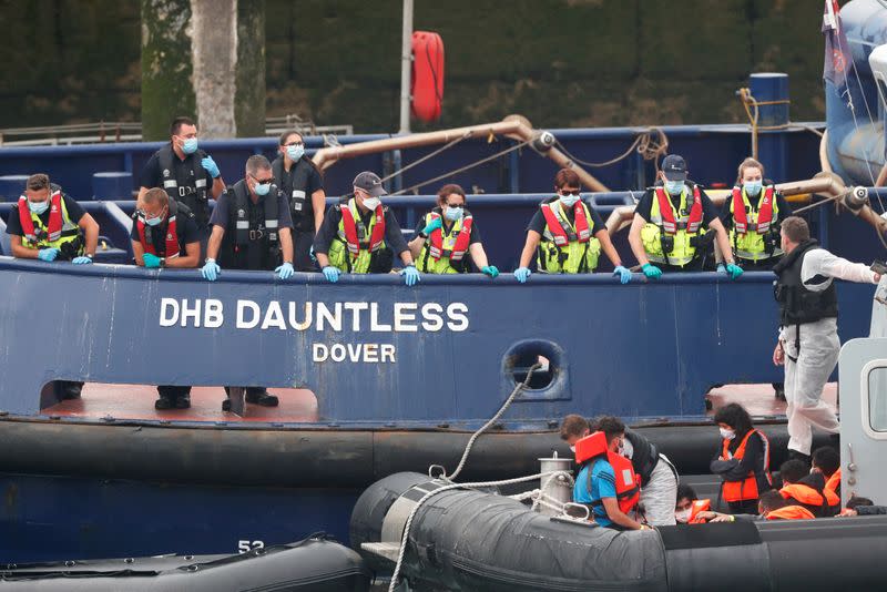 FILE PHOTO: Migrants prepare to disembark at Dover harbour, in Dover