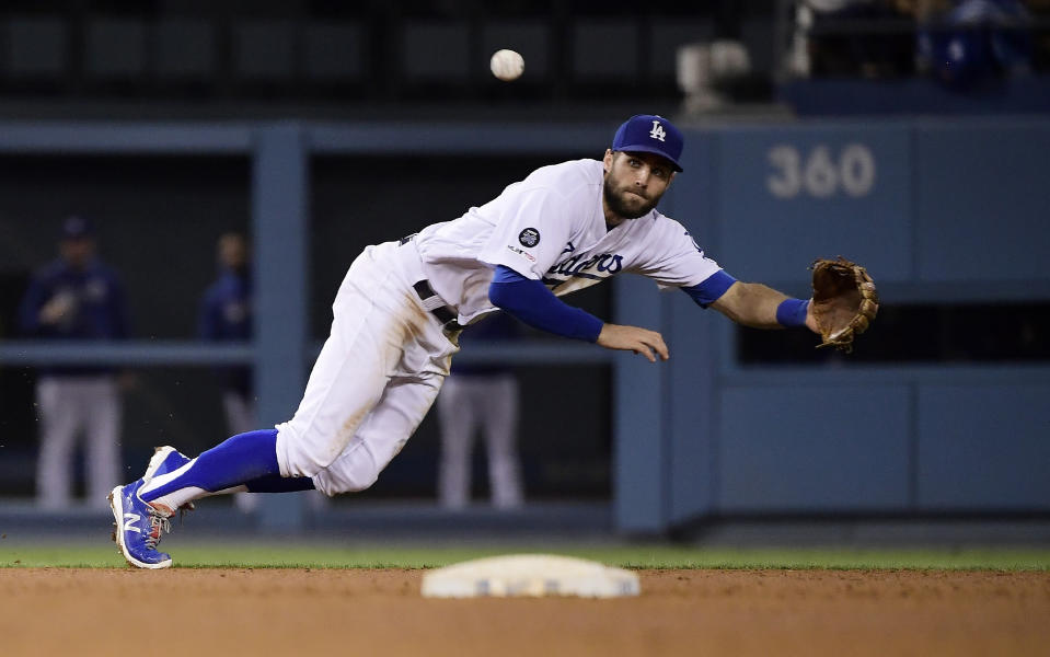 Los Angeles Dodgers shortstop Chris Taylor can't reach a ball hit for a single by San Francisco Giants' Donovan Solano during the seventh inning of a baseball game Thursday, June 20, 2019, in Los Angeles. (AP Photo/Mark J. Terrill)