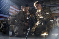 FILE - Members of the 82nd Airborne Division of the U.S. Army clean weaponry ahead of deployment to Poland from Fort Bragg, N.C. on Monday, Feb. 14, 2022. Seven decades after it was founded, the North Atlantic Treaty Organization is meeting in Madrid on June 29 and 30, 2022 with an urgent need to reassert its original mission: preventing Russian aggression against Western allies. (AP Photo/Nathan Posner, File)