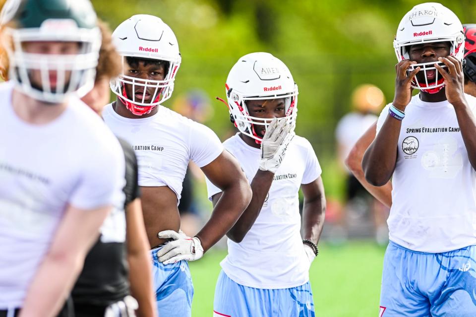 Everett's Eugene Allen, center, and other Vikings teammates look on during a MHSAA/MHSFCA spring football evaluation camp on Tuesday, May 16, 2023, at DeWitt High School.