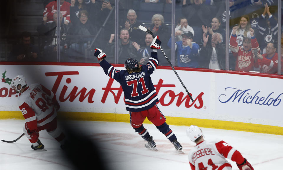 Winnipeg Jets' Axel Jonsson-Fjallby (71) celebrates a goal against the Detroit Red Wings during the second period of an NHL hockey game Wednesday, Dec. 20, 2023, in Winnipeg, Manitoba. (John Woods/The Canadian Press via AP)