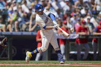 Seattle Mariners' Eugenio Suarez hits an RBI-double against the Los Angeles Angels during the first inning of a baseball game, Sunday, Aug. 7, 2022, in Seattle. (AP Photo/John Froschauer)