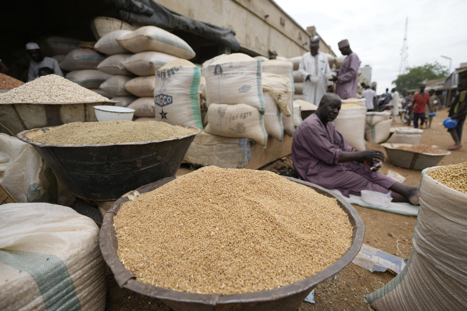 A man sells grain in Dawanau International Market in Kano Nigeria, Friday, July 14, 2023. Nigeria introduced programs before and during Russia's war in Ukraine to make Africa's largest economy self-reliant in wheat production. But climate fallout and insecurity in the northern part of the country where grains are largely grown has hindered the effort. (AP Photo/Sunday Alamba)