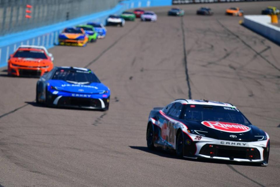 Mar 10, 2024; Avondale, Arizona, USA; NASCAR Cup Series driver Christopher Bell (20) leads a group during the Shriners Children’s 500 at Phoenix Raceway.